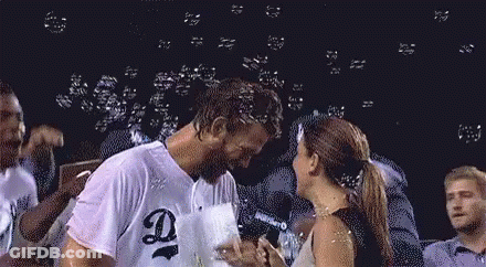 Man And Woman Kissing In Front Of Bubbles GIF