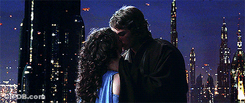 Man And Woman Kissing In Front Of City Skyline At Night GIF