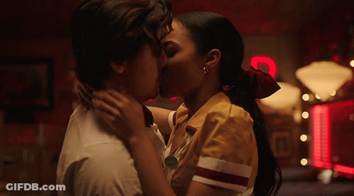 Man And Woman Kissing In Front Of Coca Cola Sign GIF