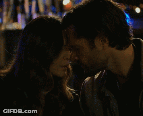 Man And Woman Kissing In Front Of Coca Cola Sign GIF