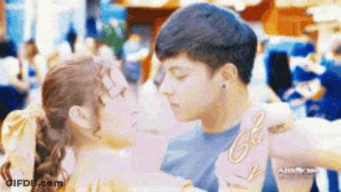 Man And Woman Kissing In Front Of Crowd GIF