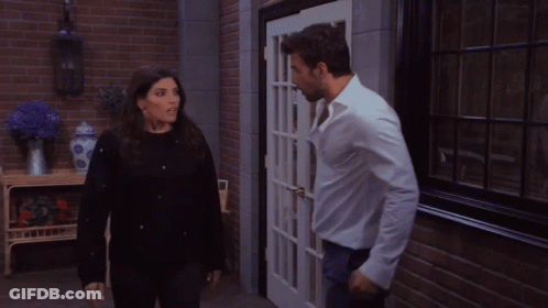 Man And Woman Kissing In Front Of Door GIF