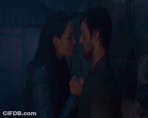 Man And Woman Kissing In Front Of Fire GIF