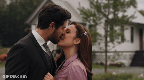 Man And Woman Kissing In Front Of House GIF
