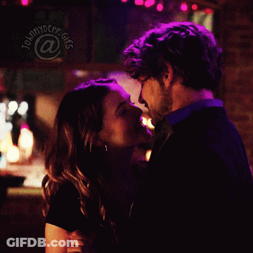 Man And Woman Kissing In Front Of Johnnydcpp GIFs Sign GIF