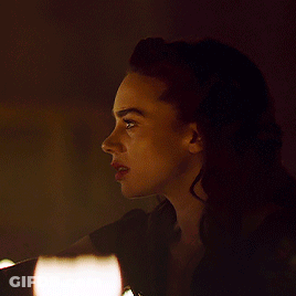 Man And Woman Kissing In Front Of Lit Candle GIF