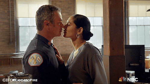Man And Woman Kissing In Front Of NBC Sign GIF