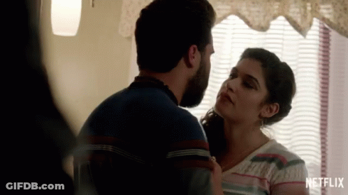 Man And Woman Kissing In Front Of Netflix GIF