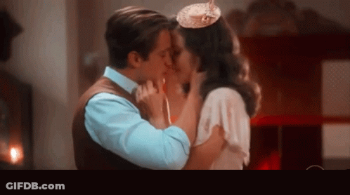 Man And Woman Kissing In Front Of O Circle GIF