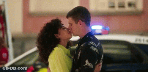 Man And Woman Kissing In Front Of Police Car GIF