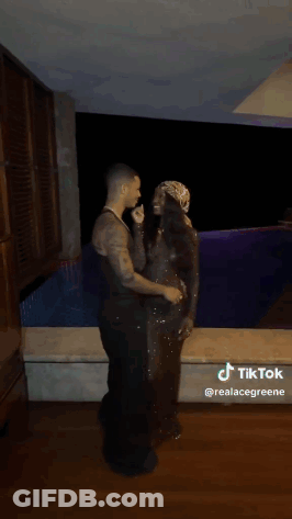 Man And Woman Kissing In Front Of Pool GIF