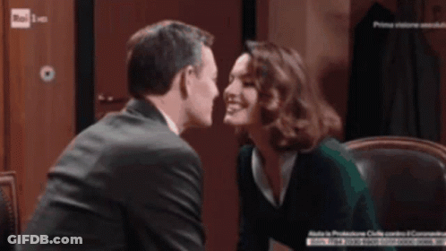 Man And Woman Kissing In Front Of Rai Sign GIF