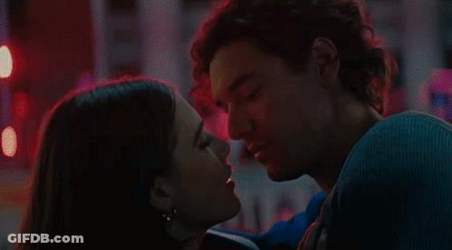 Man And Woman Kissing In Front Of Red Light GIF