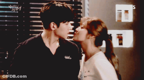 Man And Woman Kissing In Front Of SBS Sign GIF