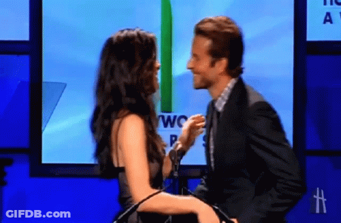 Man And Woman Kissing In Front Of Screen Saying Two GIF