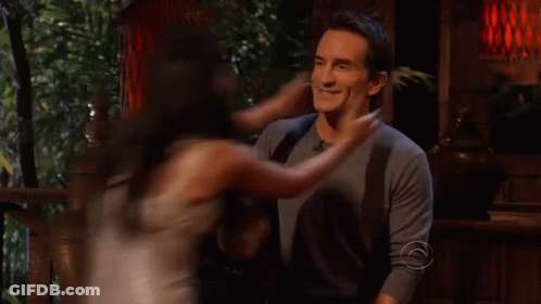 Man And Woman Kissing In Front Of Sign Saying C GIF