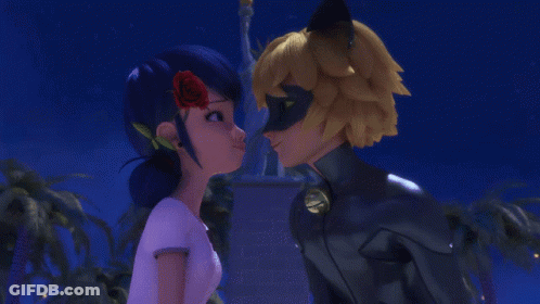 Man And Woman Kissing In Front Of Statue GIF