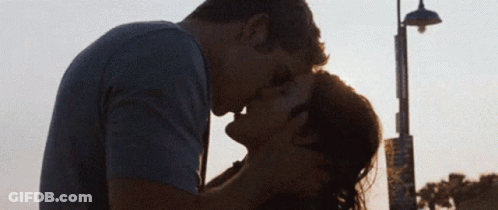 Man And Woman Kissing In Front Of Street Light GIF