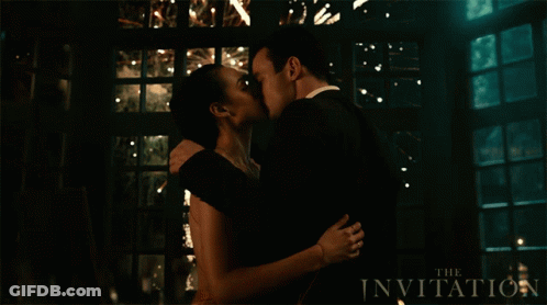 Man And Woman Kissing In Front Of The Invitation Sign GIF