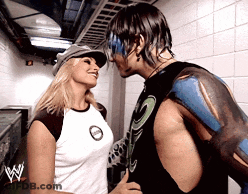 Man And Woman Kissing In Front Of W Logo GIF