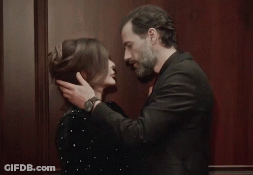 Man And Woman Kissing In Front Of Wall GIF