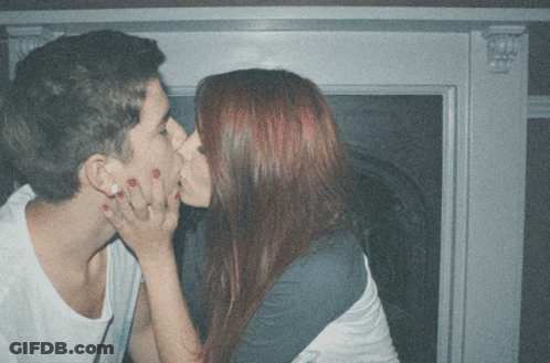 Man And Woman Kissing In Front Of Window GIF