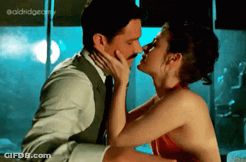 Man And Woman Kissing In Front Of Window GIF