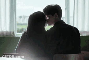 Man And Woman Kissing In Front Of Window GIF