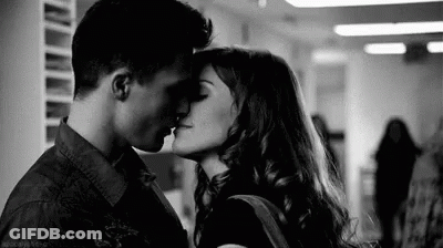 Man And Woman Kissing In Hallway GIF