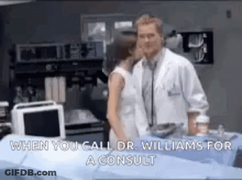 Man And Woman Kissing In Hospital Room While Doctor Listens GIF
