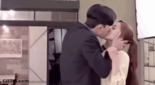 Man And Woman Kissing In Living Room GIF