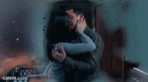Man And Woman Kissing In Living Room GIF