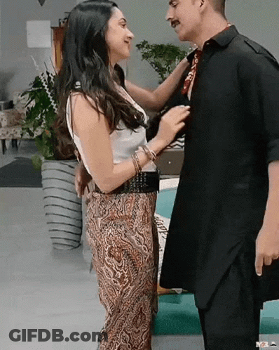 Man And Woman Kissing In Living Room GIF