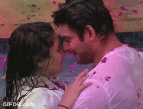 Man And Woman Kissing In Petal Pool GIF