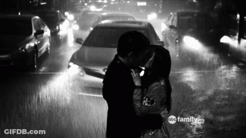 Man And Woman Kissing In Rain GIF
