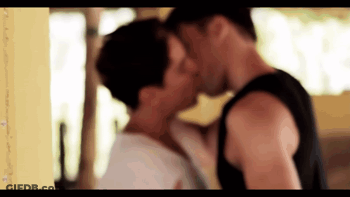 Man And Woman Kissing In Room GIF
