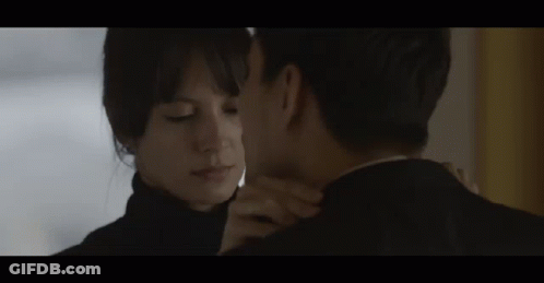 Man And Woman Kissing In Room GIF