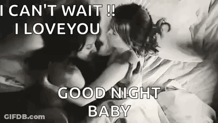 Man And Woman Kissing On A Bed GIF