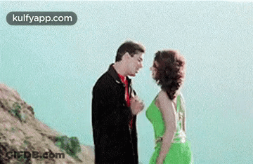 Man And Woman Kissing On A Hill GIF