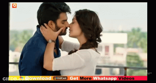 Man And Woman Kissing On Balcony GIF