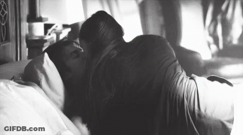 Man And Woman Kissing On Bed GIF