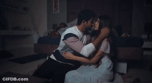 Man And Woman Kissing On Bedroom Floor GIF