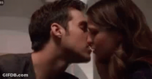 Man And Woman Kissing On Cheek GIF