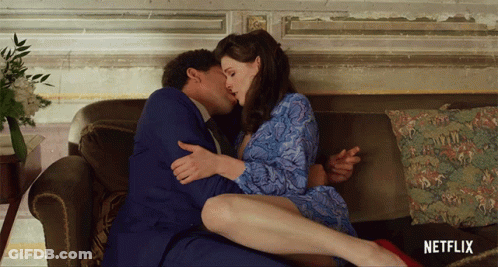Man And Woman Kissing On Couch With Netflix Logo GIF