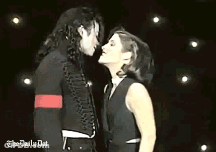 Man And Woman Kissing On Stage In Front Of Crowd GIF