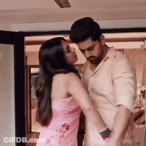 Man And Woman Kissing Under Ceiling Fan GIF