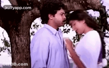 Man And Woman Kissing Under Tree GIF