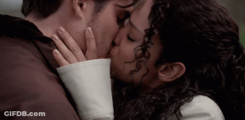 Man And Woman Kissing With Hands On Faces GIF