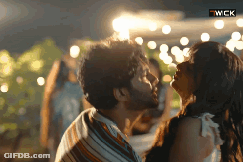 Man And Woman Kissing With Wick Logo GIF