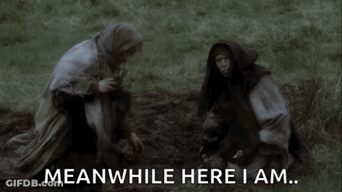 Man And Woman Kneeling In Grass Saying Meanwhile Here I Am GIF